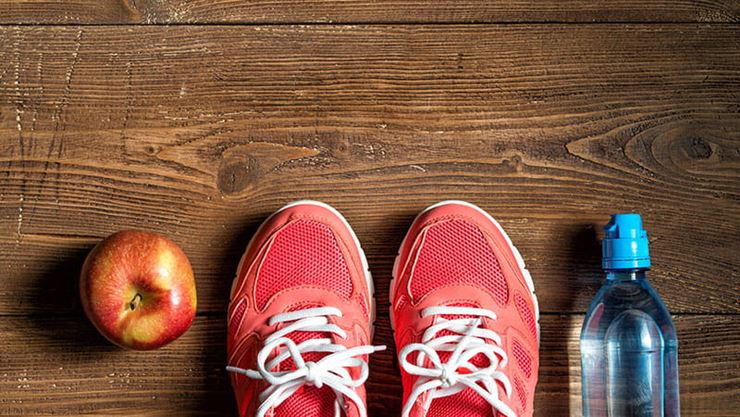 Sneakers, apple and water bottle